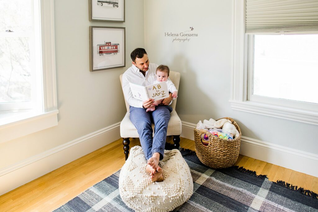 dad and son read in nursery during Lifestyle Family Portraits in Weston MA