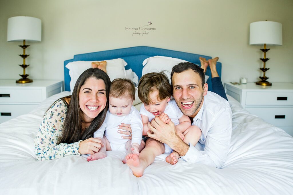 family of four plays on bed during Lifestyle Family Portraits in Weston MA