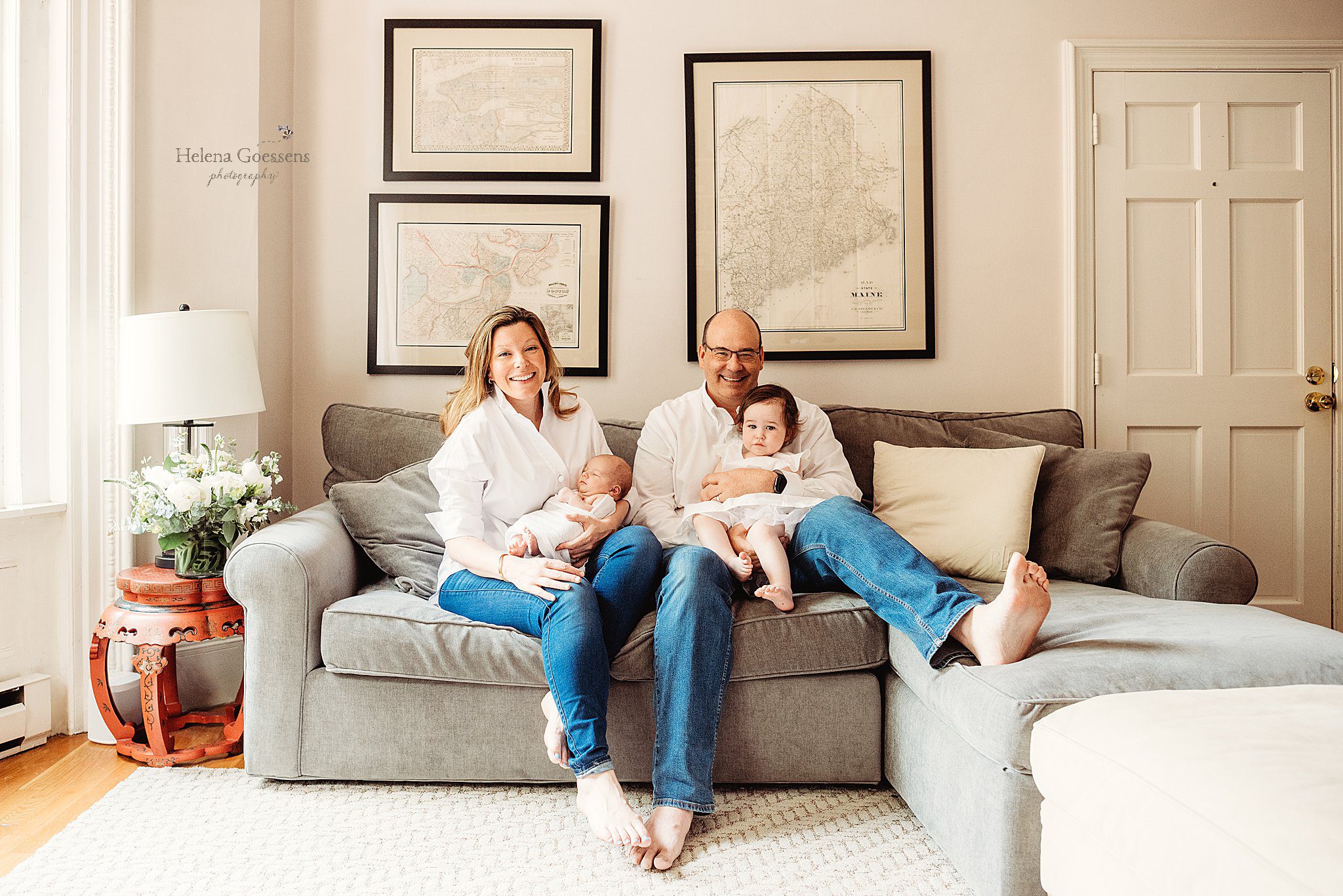 family of four sits on couch in living room during South End family portraits 