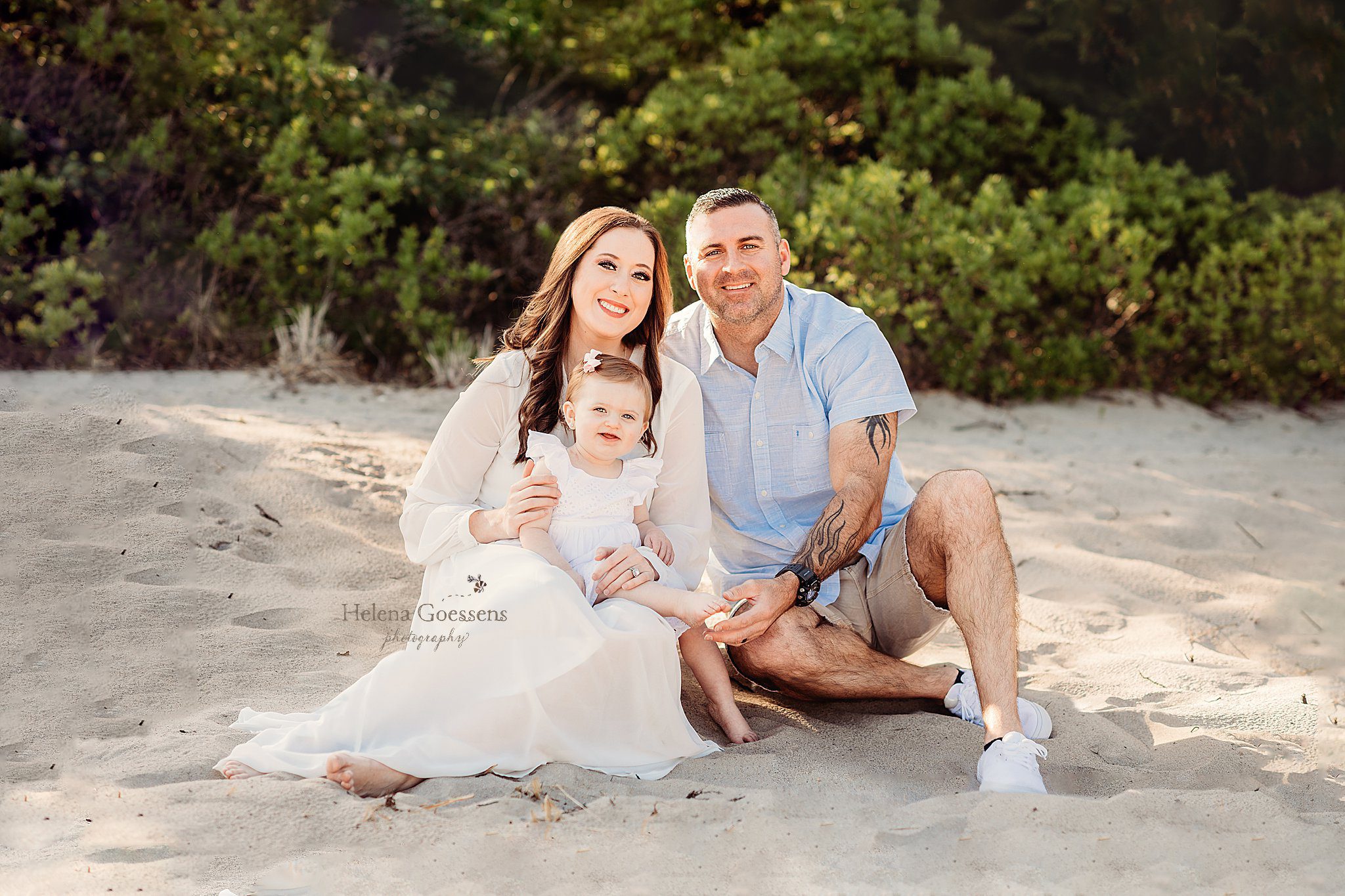 parents sit with toddler during family photos in Massachusetts 