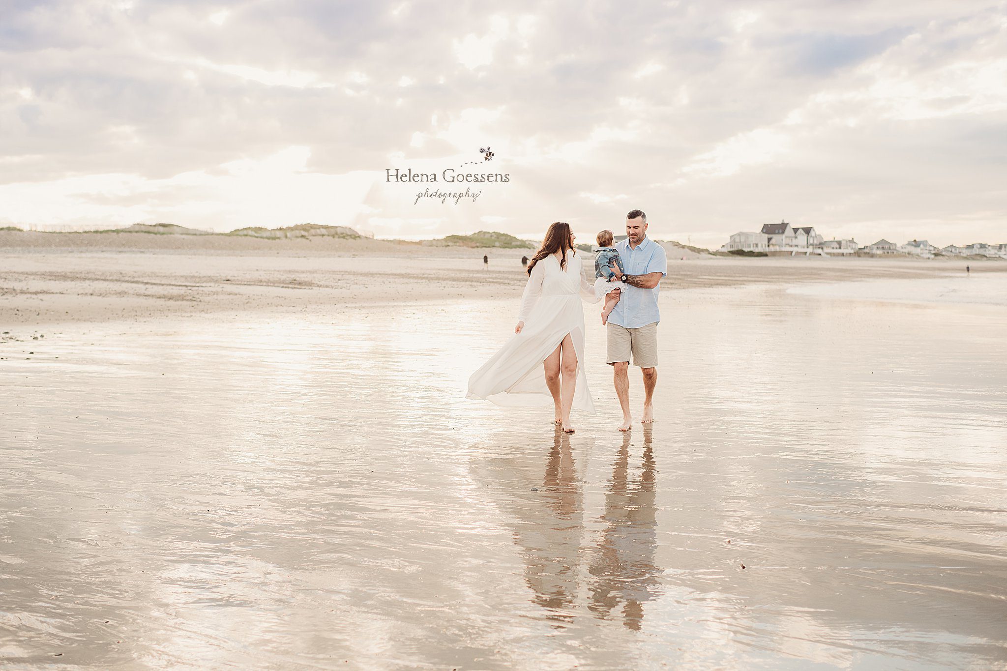 parents walk through water during Rexhame Beach family session with Helena Goessens Photography 