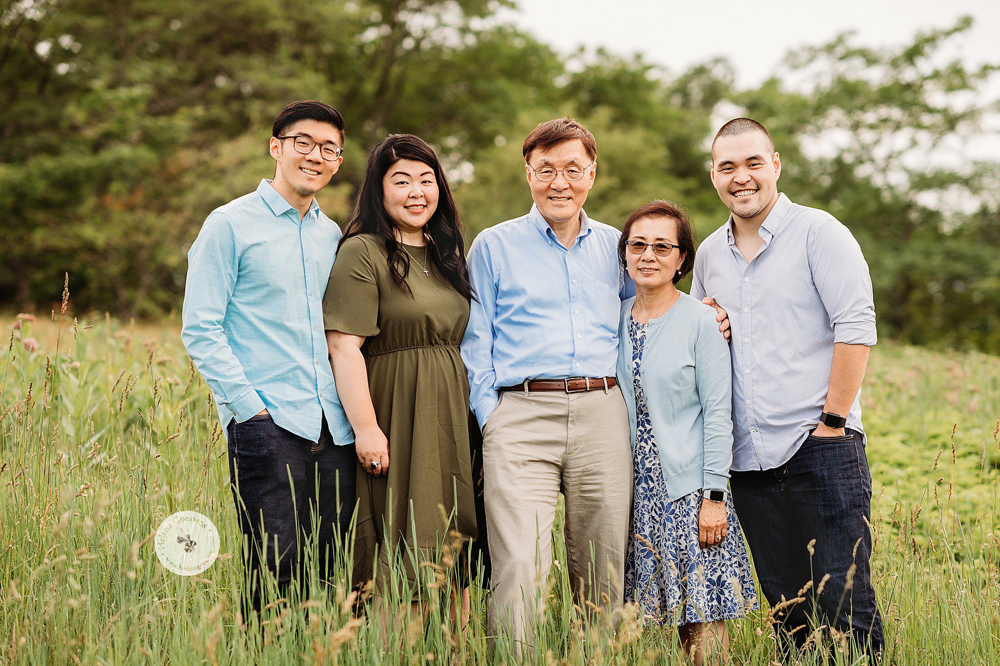 parents pose with children during Boston family photos in field