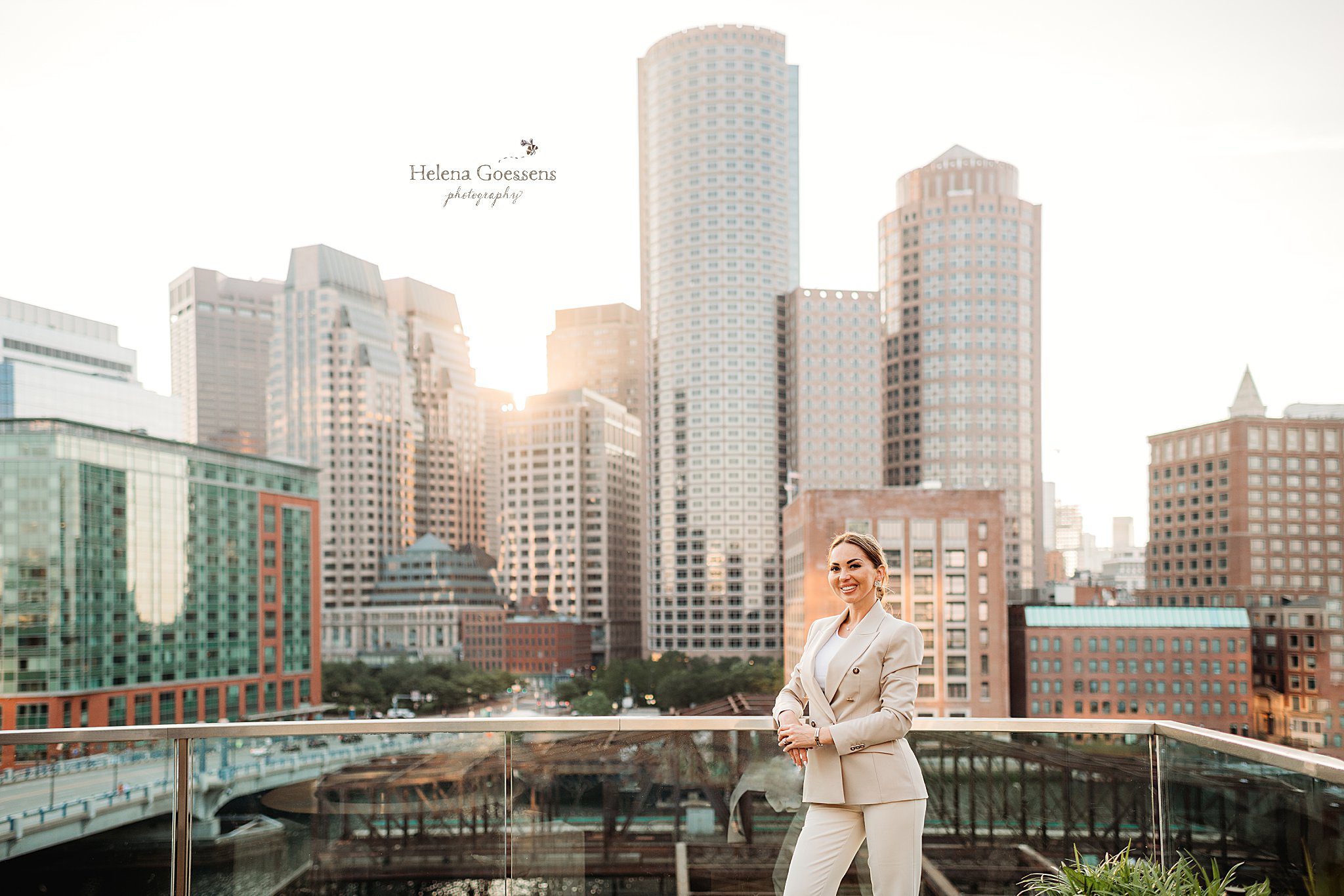 real estate agent poses on rooftop bar during Seaport Headshot session