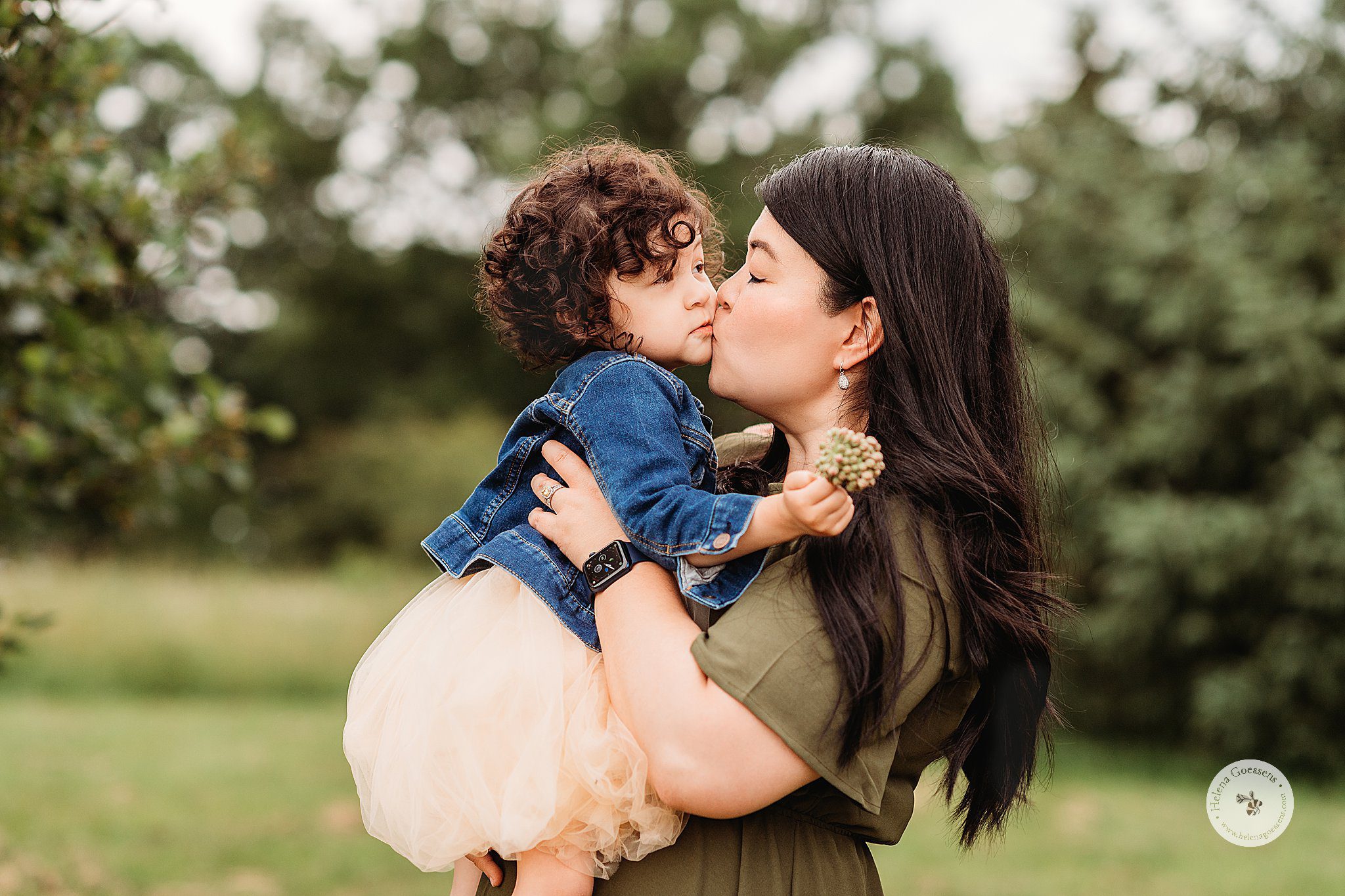 mom kisses toddler during MA family photos in Jamaica Plain