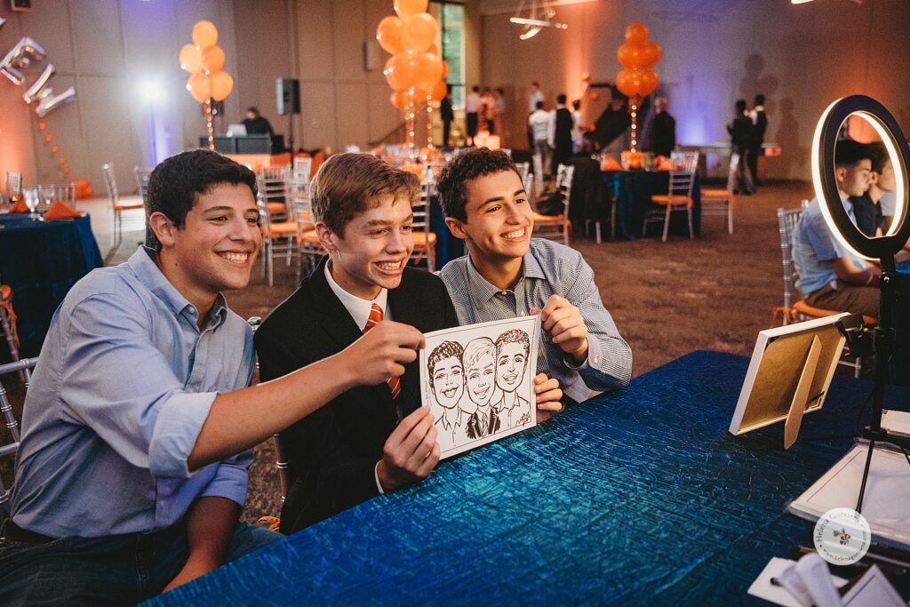 boys pose with caricatures during Bar Mitzvah at the Temple Beth Avodah