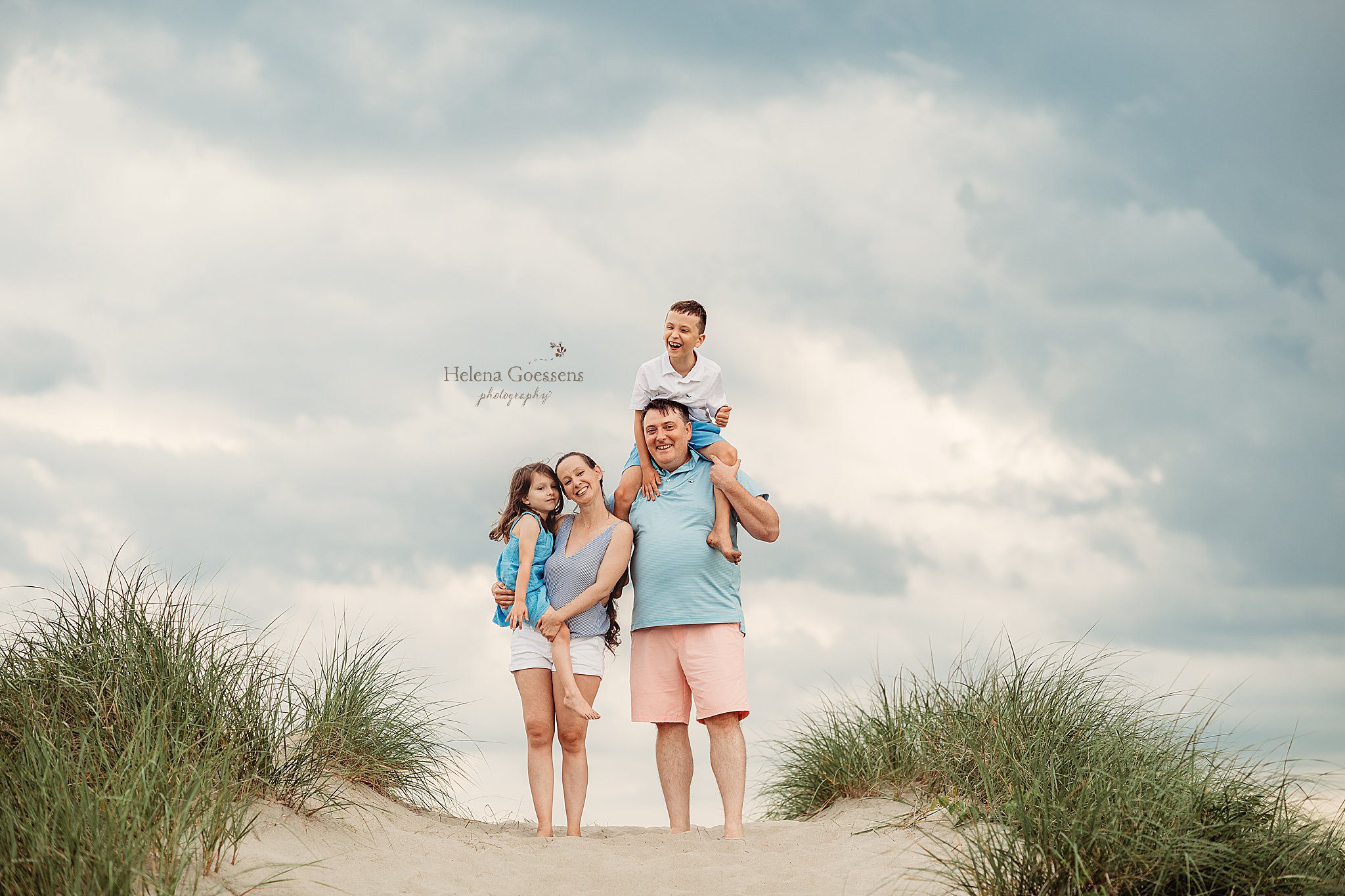 family poses on dunes during Rexhame Beach Family Photos 