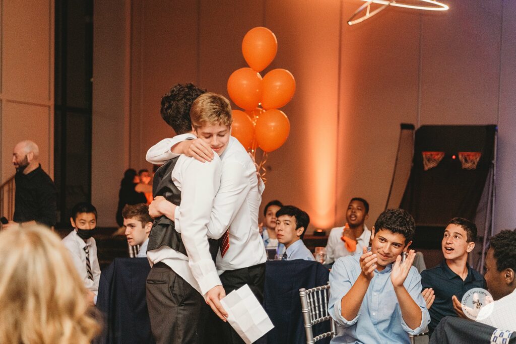young man hugs brother during celebration for Bar Mitzvah