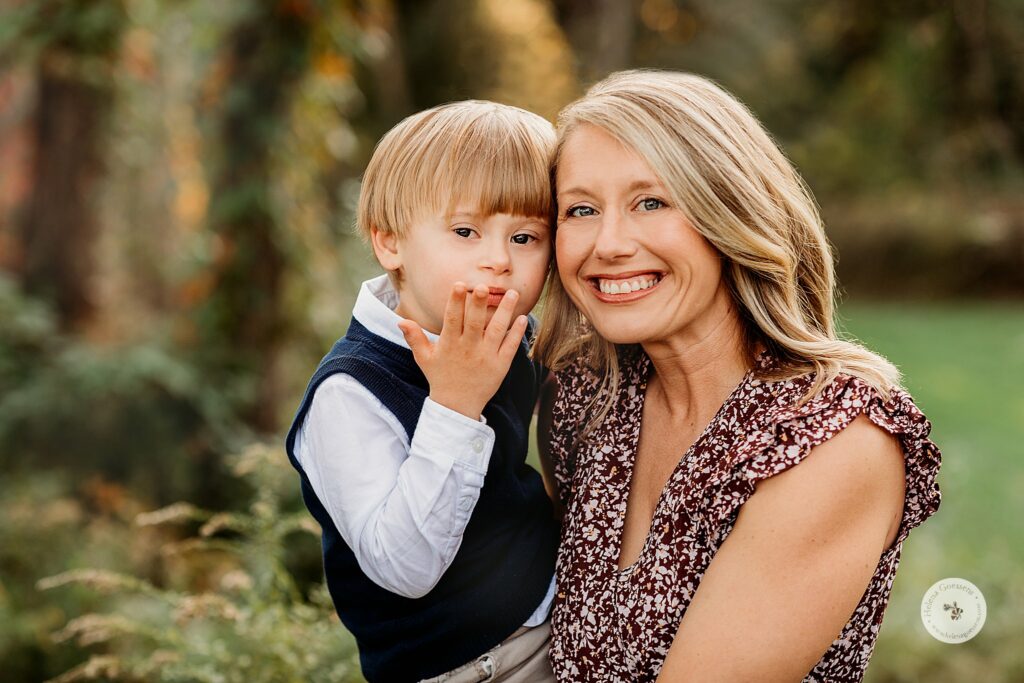 mom and son hug during fall family portraits at Larz Anderson Park