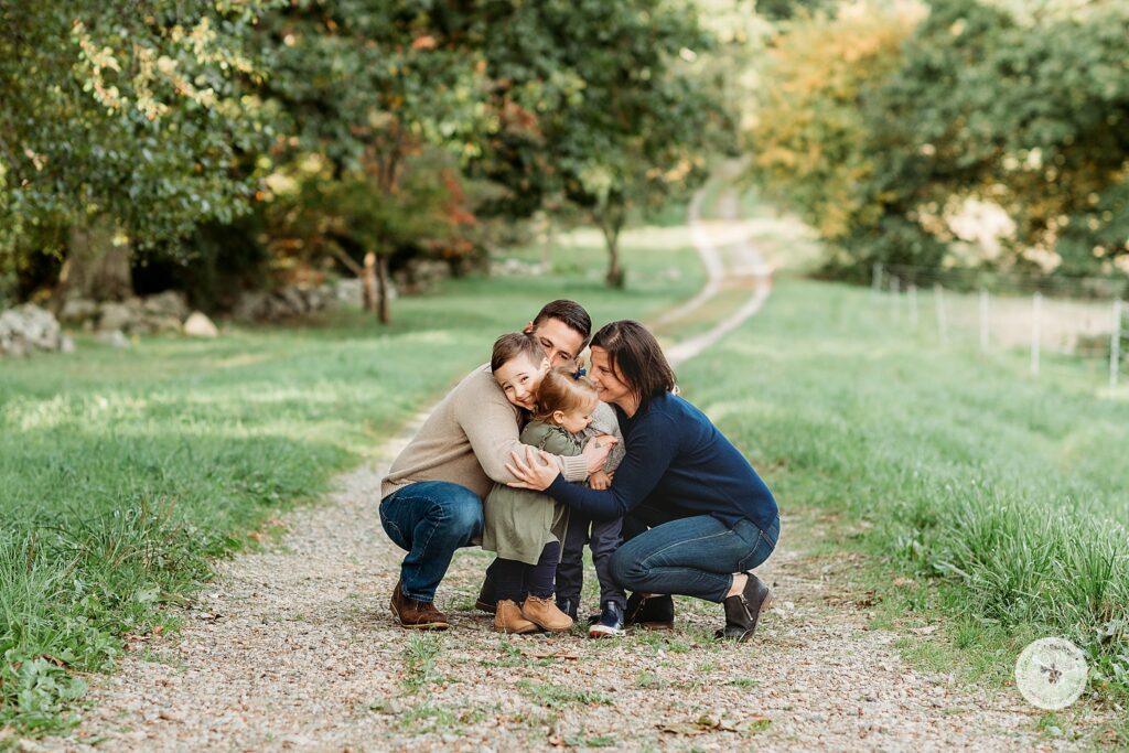 parents hug two young children during fall portraits at the Bradley Estate