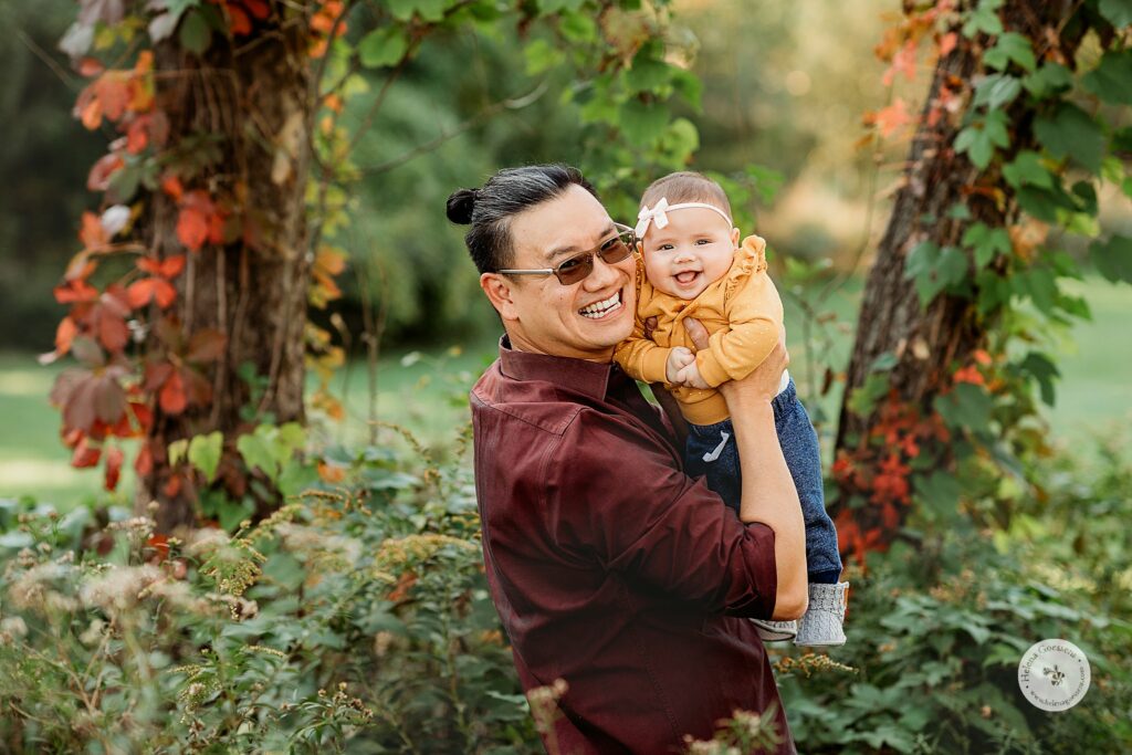 dad holds daughter during fall family photos in Brookline MA