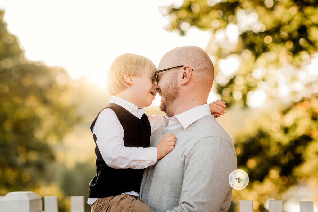 dad and son stand nose to nose during family photos in Brookline MA