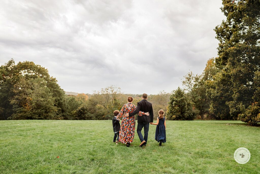 family walks through Larz Anderson Park during fall family photos