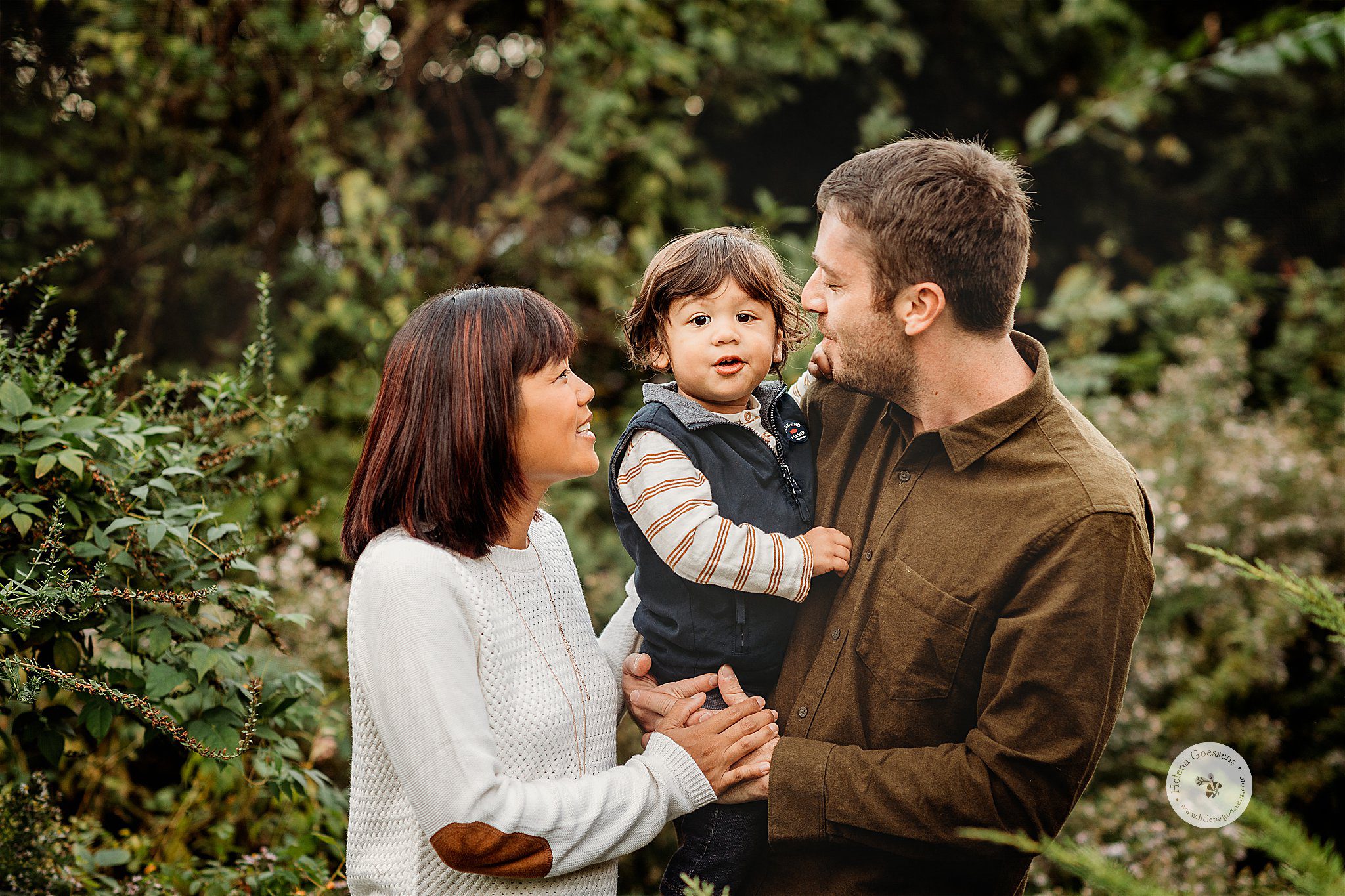 family of three poses in backyard during Lifestyle Fall Family Portraits