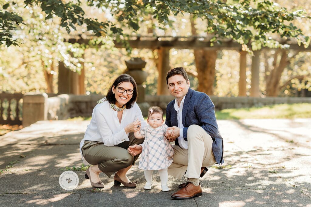 parents pose with toddler during fall Larz Anderson Park family portraits