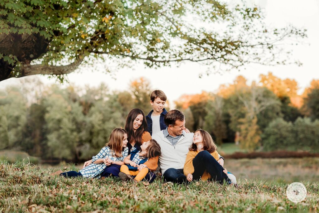 parents sit with four kids during family portraits at the Old Manse