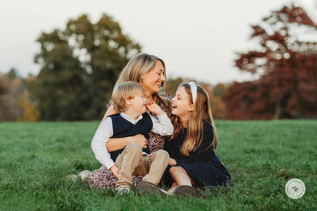 mom laughs with son and daughter during fall family photos in Brookline MA