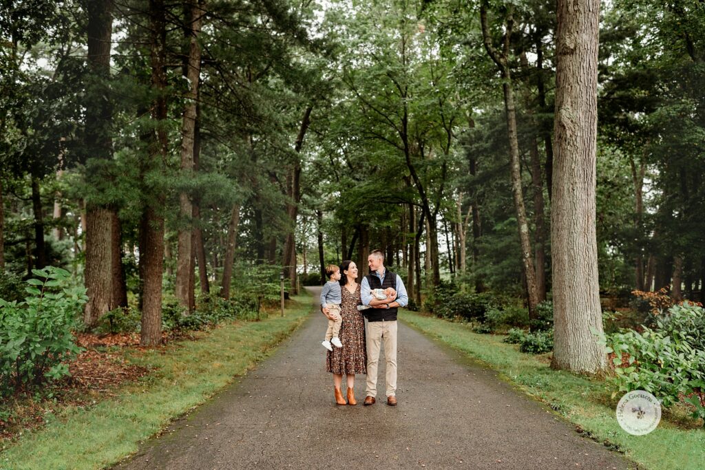 Helena Goessens photographs family of four on driveway during Fall Family Portraits at the Bradley Estate