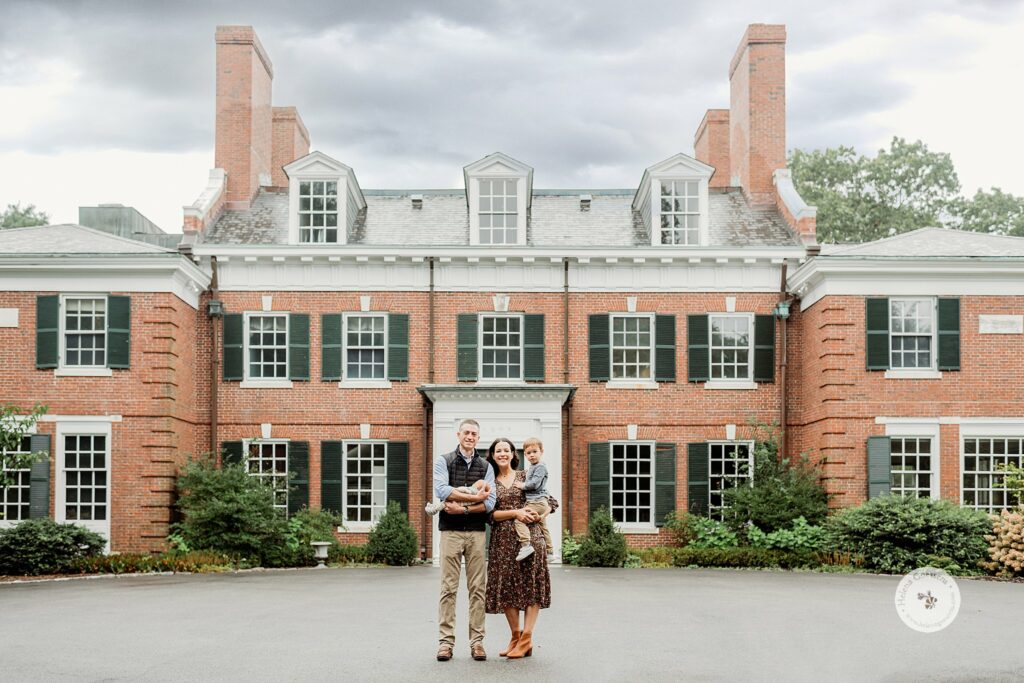 family of four poses outside Bradley Estate in Canton MA