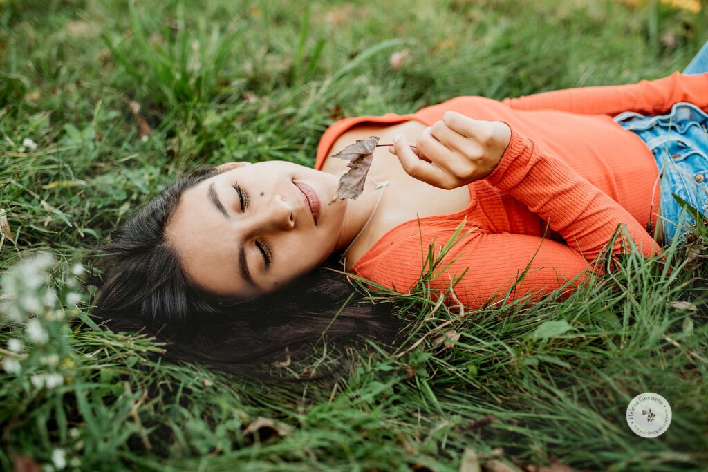 teen lays in grass with leaf during The Old Manse Family Portraits