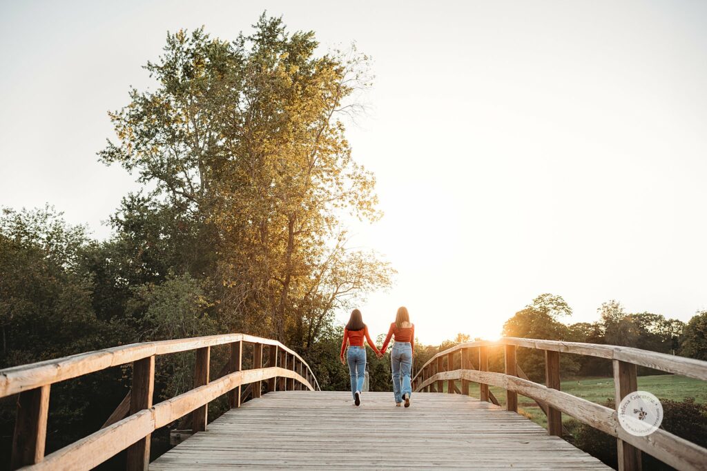 twin sisters walk over bridge at The Old Manse 