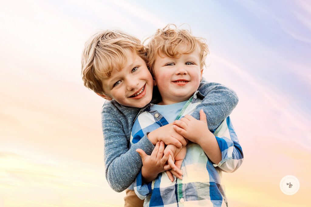 brothers hug during Brookline MA family portraits at sunset 