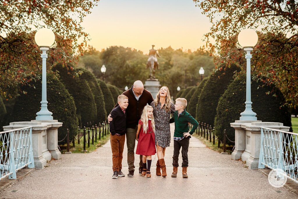 family of five laughs together on bridge during Public Garden Family Portraits
