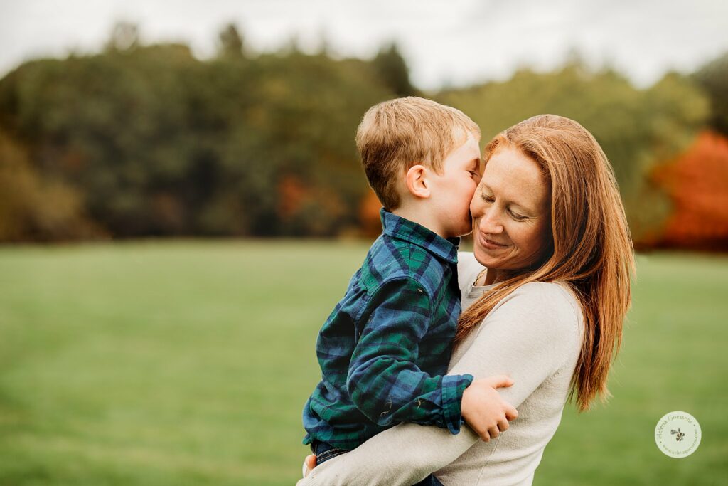 toddler kisses mom during Fall Family Portraits at Larz Anderson Park