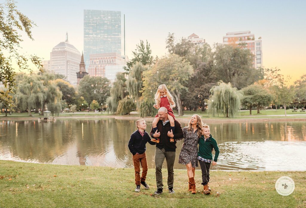 family of five walks through Boston Public Garden during family photos 