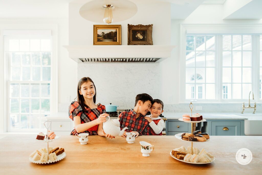 Weston MA Lifestyle Holiday Family Portraits for kids with holiday cakes and tea set 
