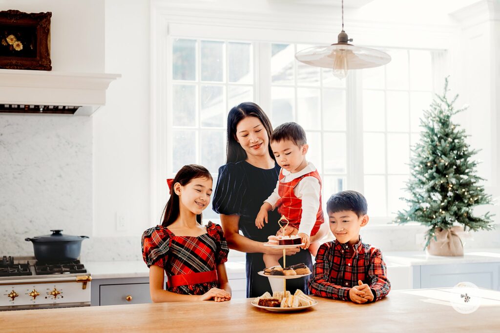 mom stands with kids eating cakes during Weston MA Lifestyle Holiday Family Portraits