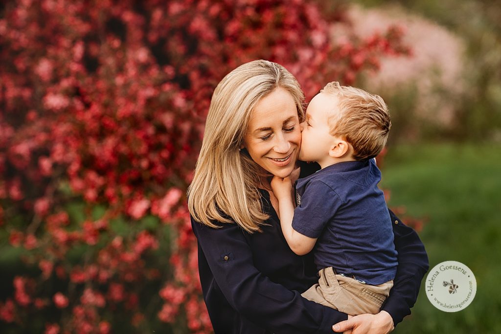 toddler kisses mom's cheek during spring family photos