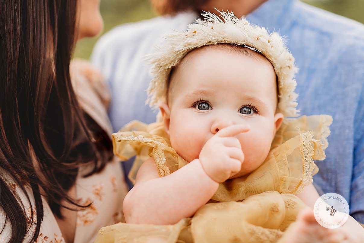 baby girl sucks on her thumb during family photos on Peter's Hill 
