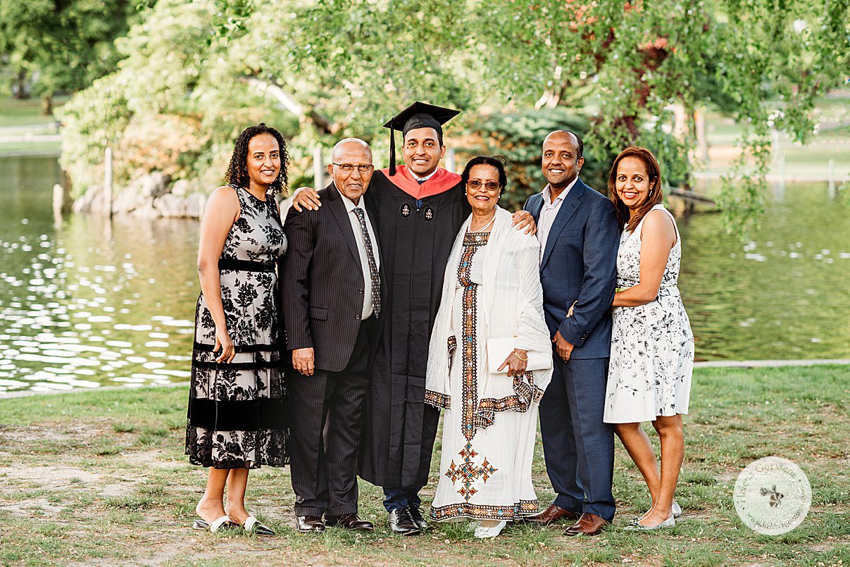 family stands together during Boston family photos for Harvard graduate 