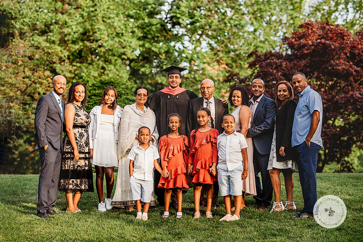 Harvard graduate poses with extended family during senior portraits at Boston Public Garden