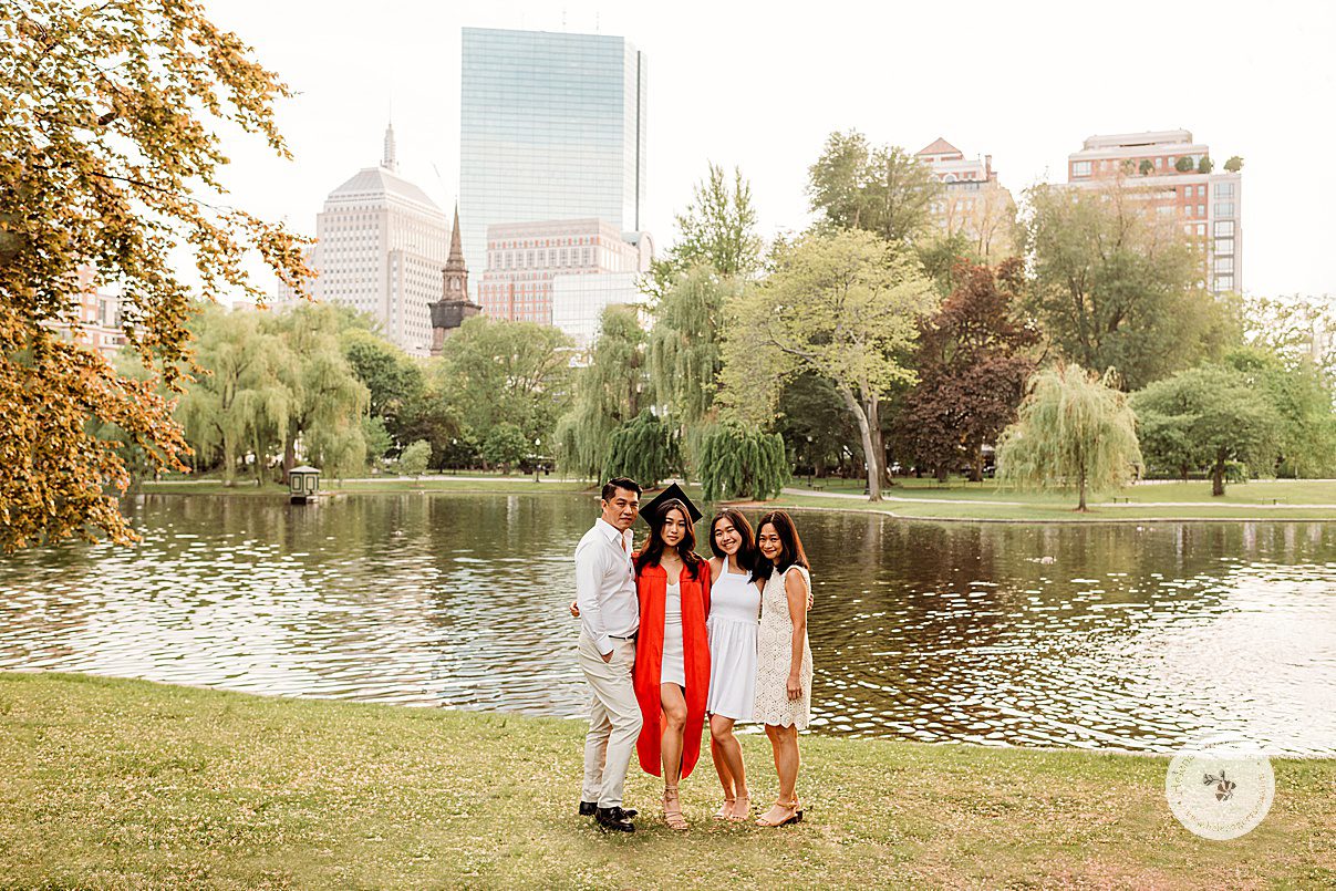 parents and sister pose with BU college graduate in front of pond at Boston Public Garden 