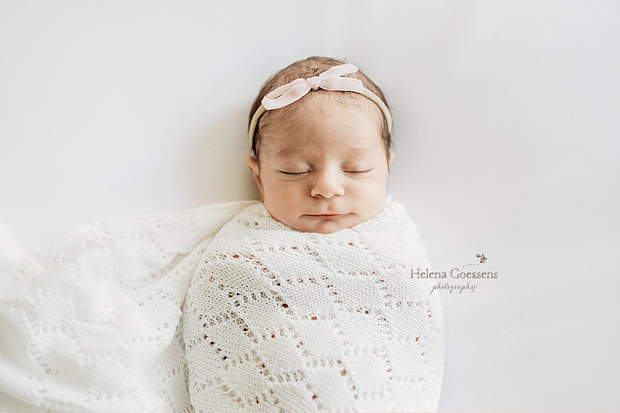 baby girl sleeps in knit blanket with thin bow during MA newborn session 