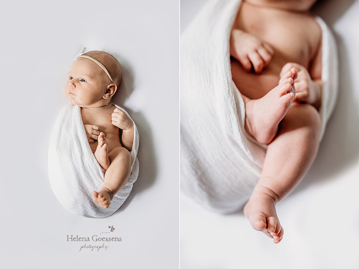 baby girl lays with legs out of white wrap during lifestyle newborn session in Newton