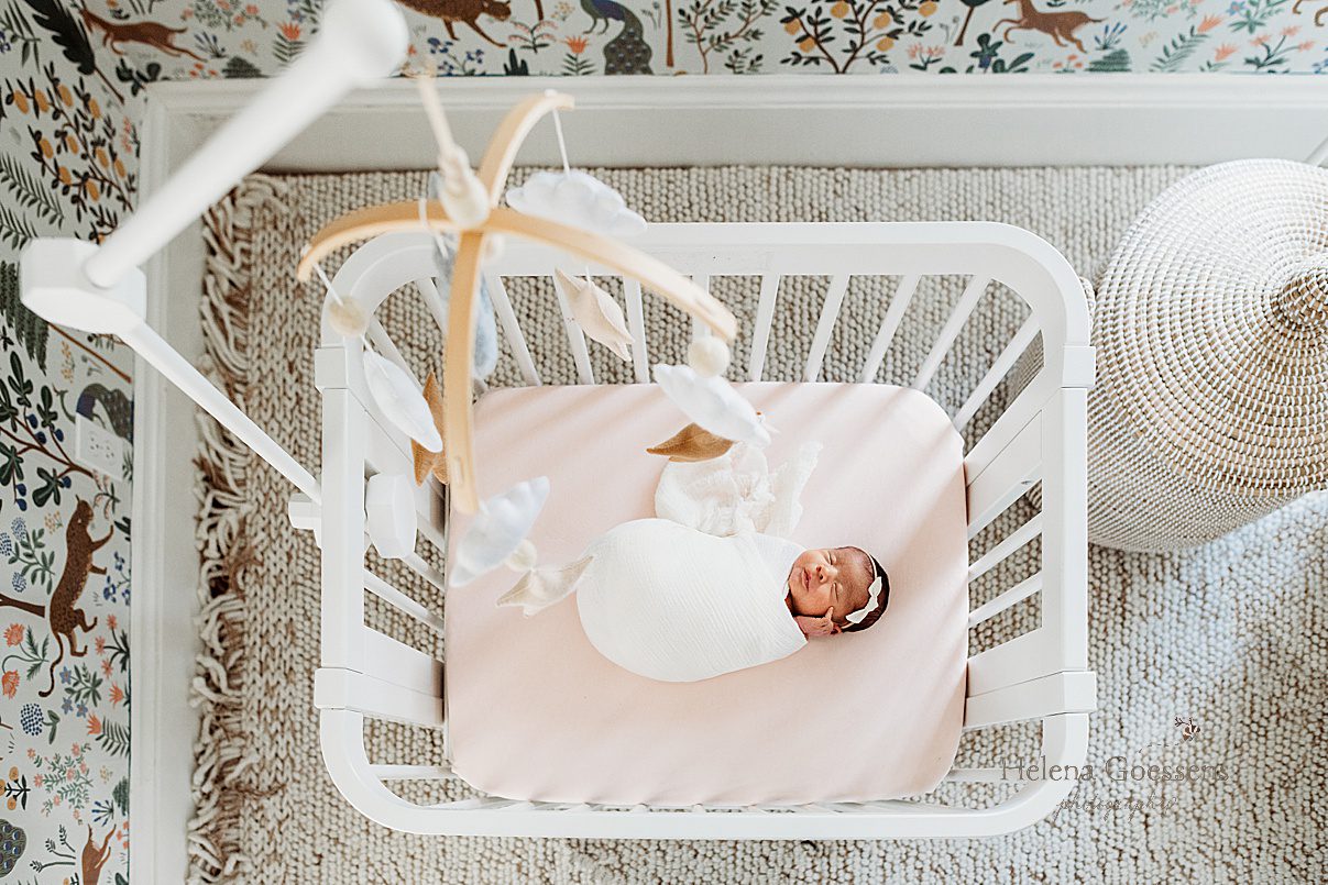 baby sleeps in white crib with pink sheets during Dedham MA lifestyle newborn portraits 