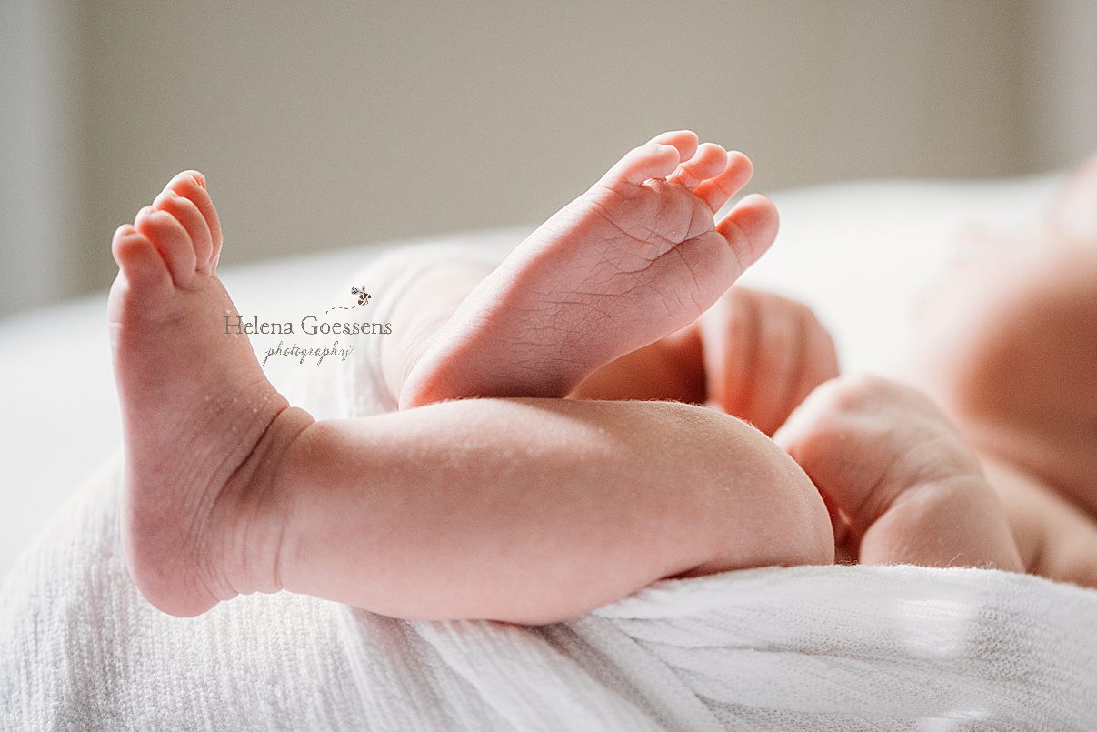 baby's feet peek out of wrap during lifestyle newborn session