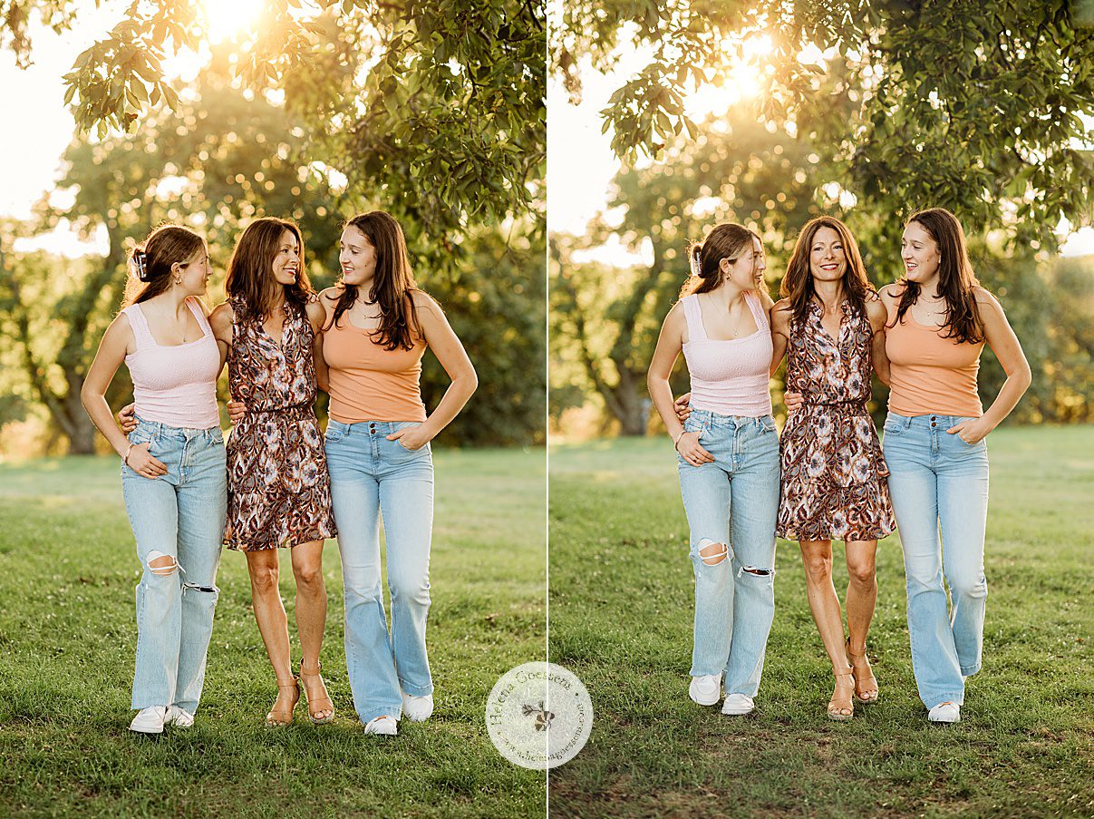 mom stands wit two teenage daughters in jeans and tank tops during fall family photos at Larz Anderson Park