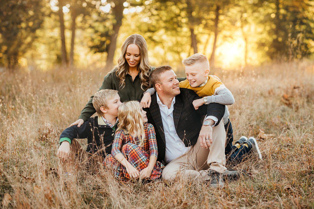 Family of five sitting on the ground looking at each other. Boston Newborn and Family Photographer Helena Goessens Photography - Fall Family Session