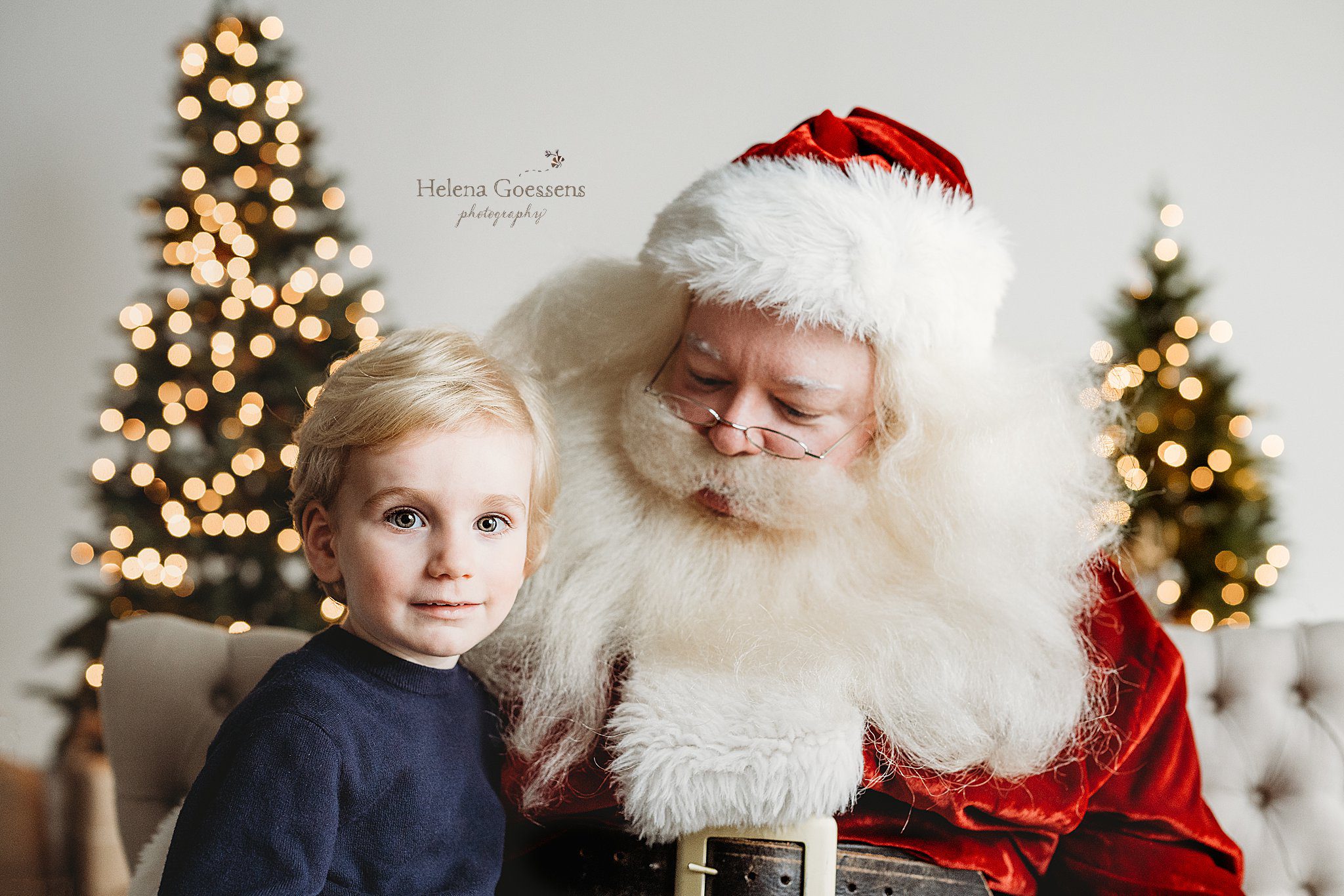 blonde boy sits on Santa's lap during classic holiday studio mini sessions 
