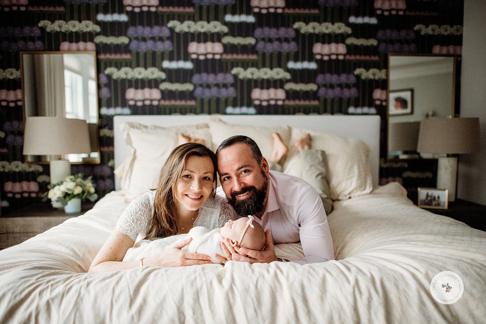 mom and dad lay on bed holding baby girl during Dover MA Lifestyle Newborn Session