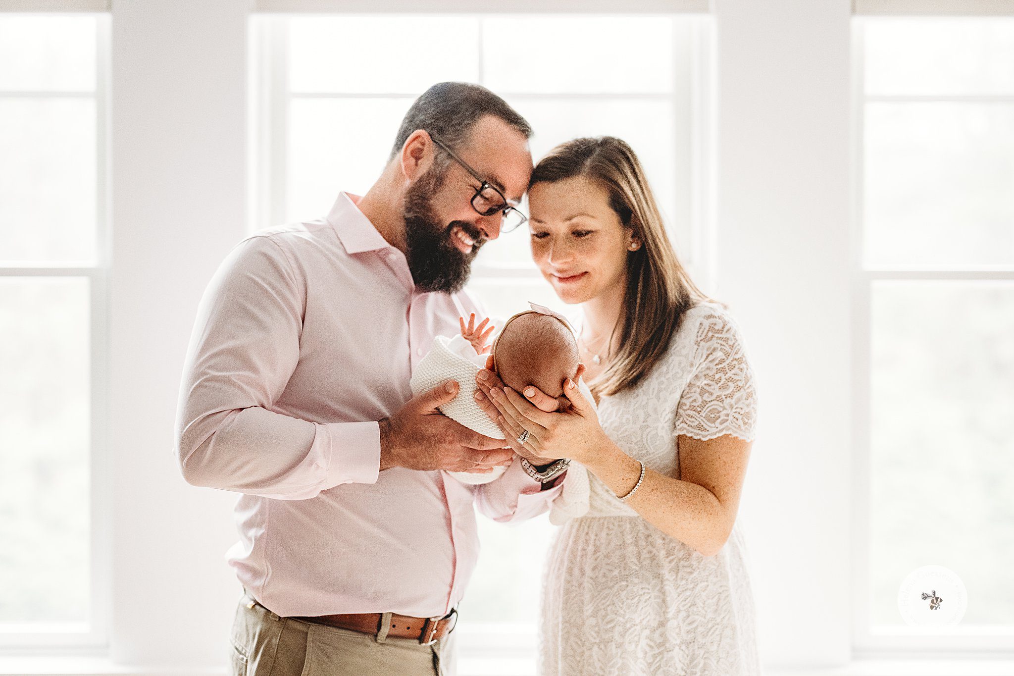 paneers stand together with daughter in front of window during Dover MA Lifestyle Newborn Session