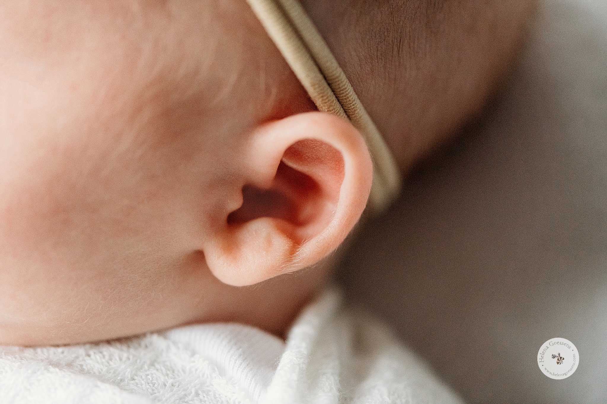 detail photo of baby's ear and headband 