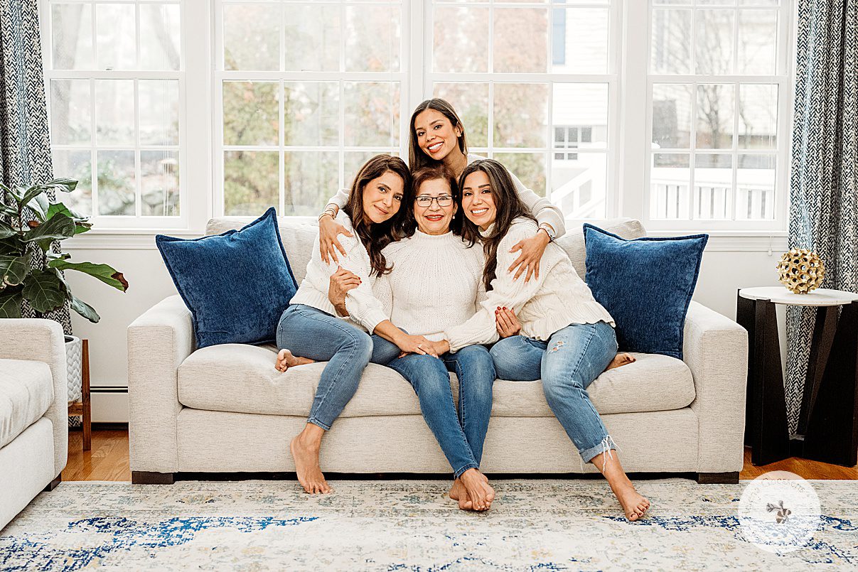 sisters hug mom on couch during generational family portraits in Boston MA
