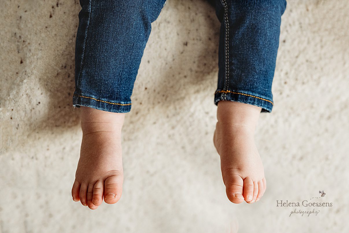 toddler toes on blanket in jeans 