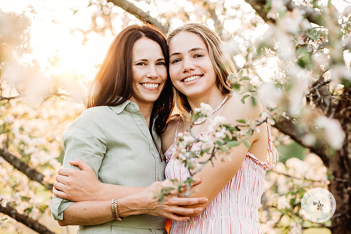 mom and daughter hug between tree branches at Arnold Arboretum 