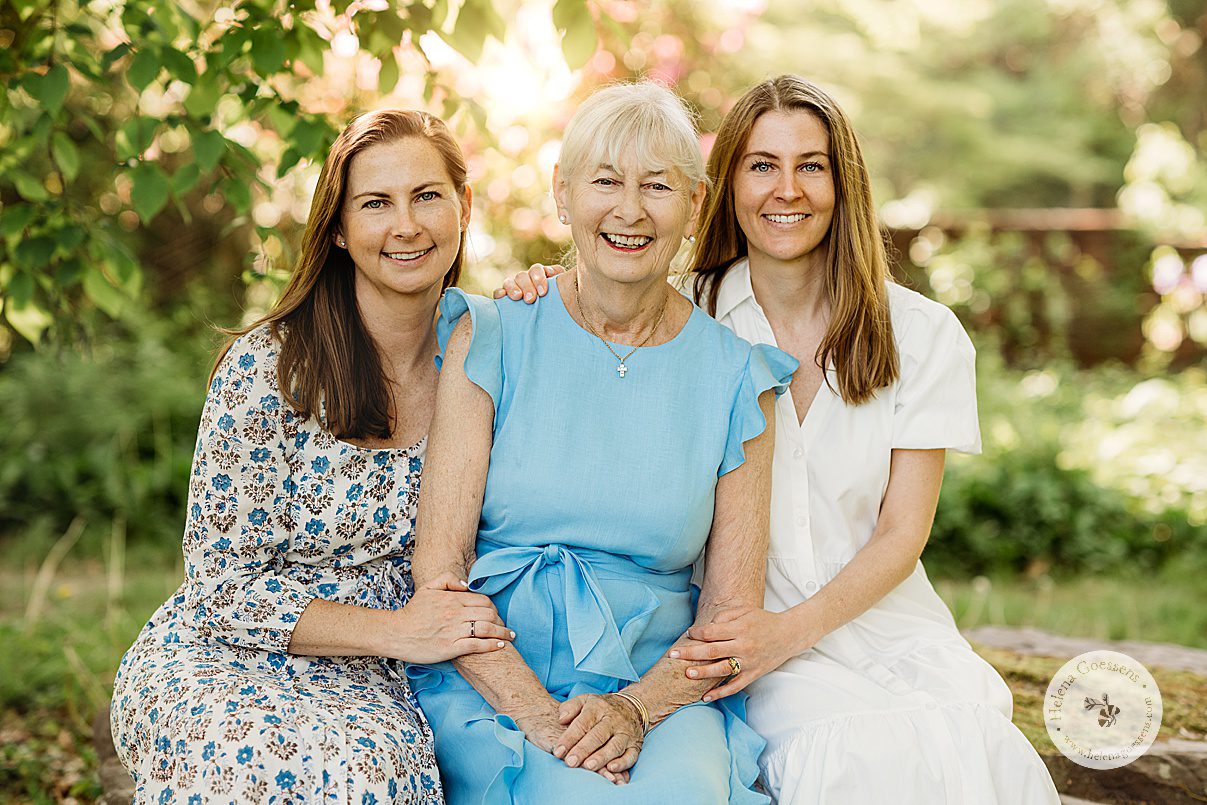 woman in light blue dress sits with two daughters during Bradley Estate family photos