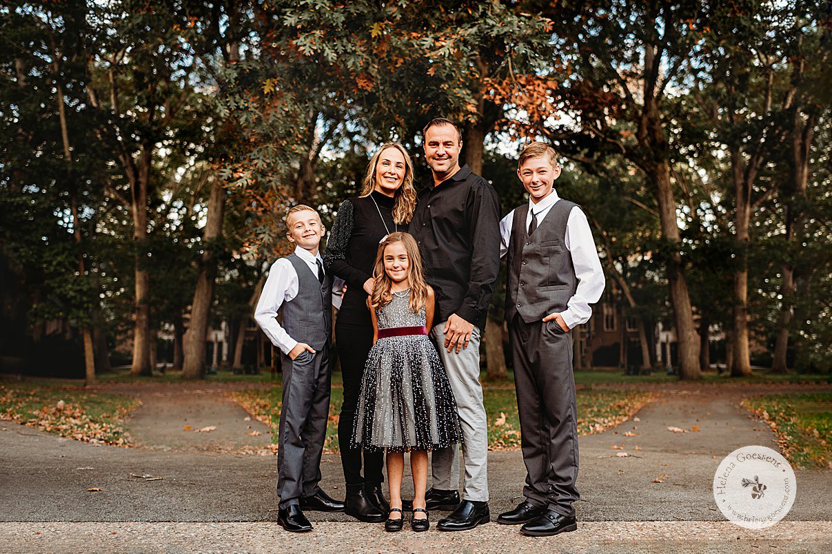 family of five stands together during elegant fall family portraits in Wellesley College
